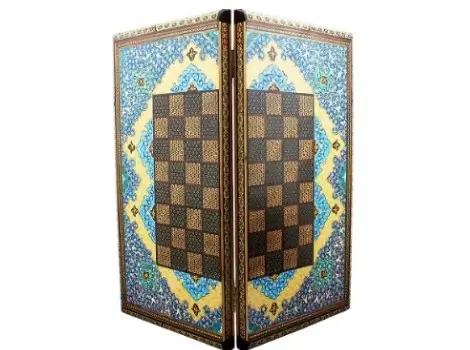 Angled view of Persian chess board with detailed Tazhib illumination